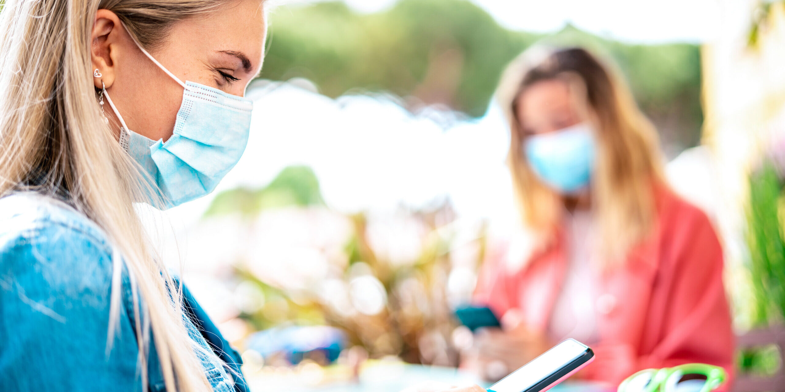 Young woman checking contact tracing app on mobile smartphone – contact tracing